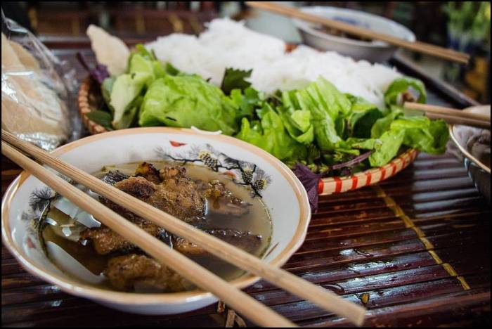 bun cha - Hanoi’s classic - is absolutely delicious charcoal-grilled pork served in a soup with fish sauce and accompanied with rice noodles and fresh leafy greens Hanoi